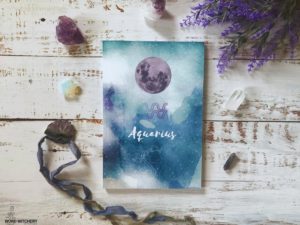 Aquarius Journal surrounded by amethyst crystals